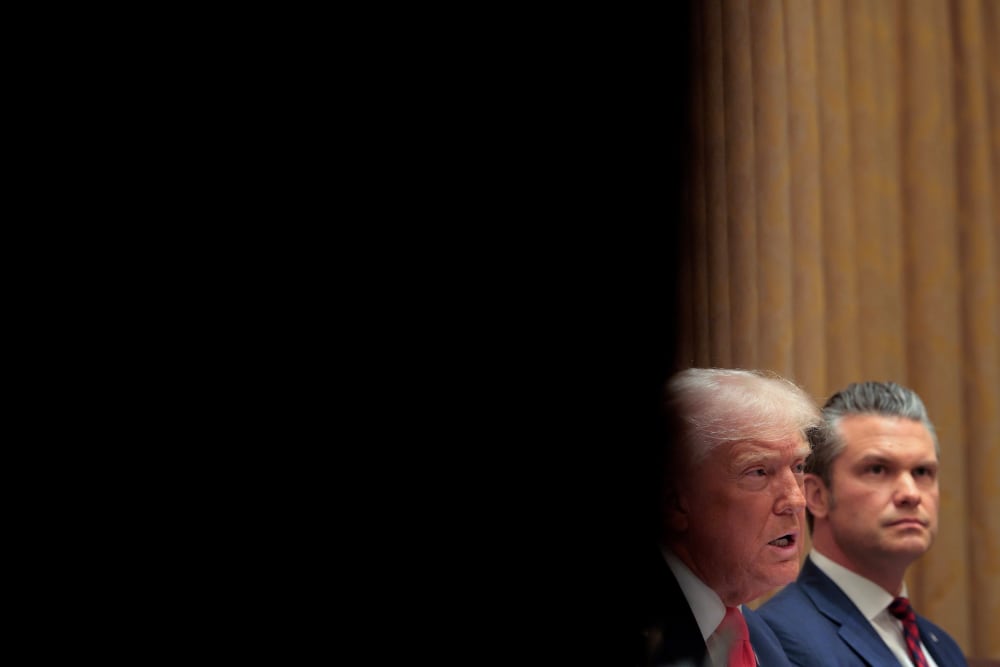 Donald Trump and Pete Hegseth sit in a Cabinet meeting