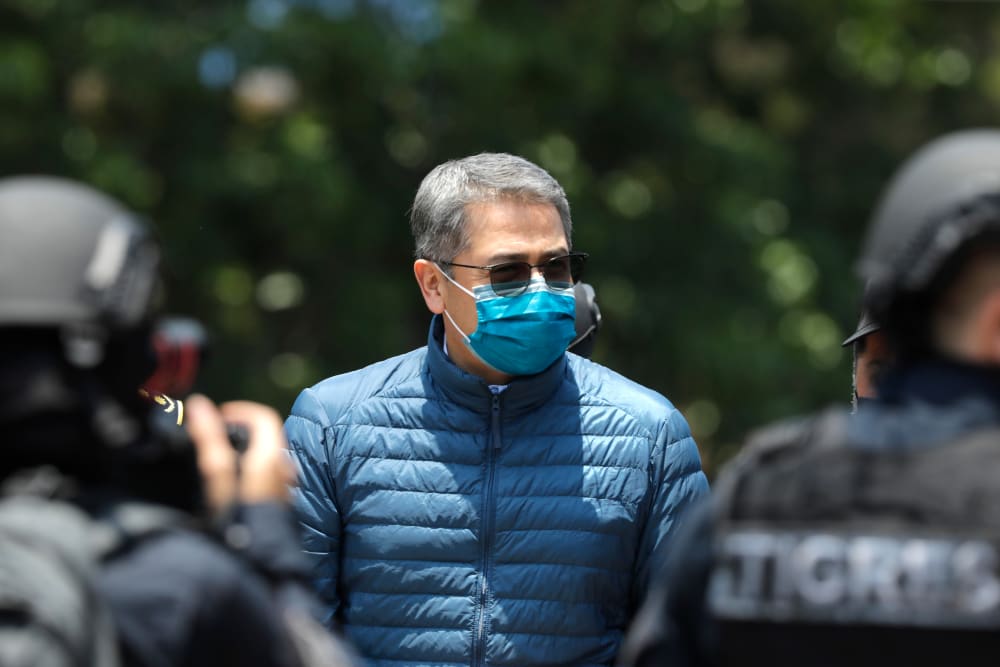 Former President of Honduras Juan Orlando Hernandez is escorted by Members of the Police Special Forces to be extradited to the U.S. to face charges of taking bribes from drug traffickers at Honduran National Directorate of Special Forces on April 21, 2022, in Tegucigalpa, Honduras.