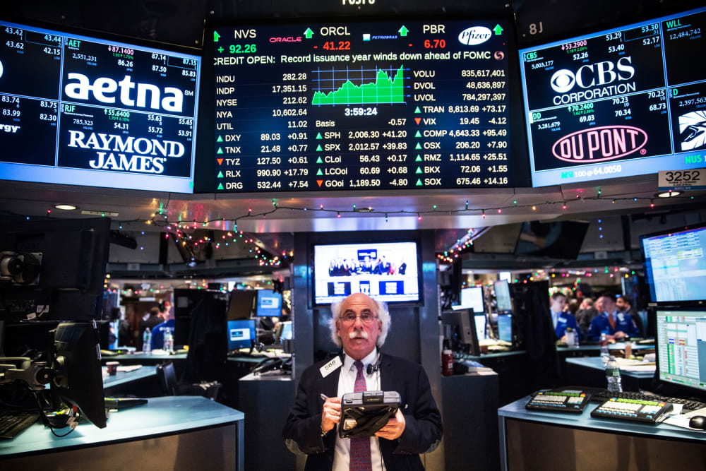A trader works on the floor of the New York Stock Exchange during the afternoon of Dec. 17, 2014 in New York, N.Y. (Photo by Andrew Burton/Getty)