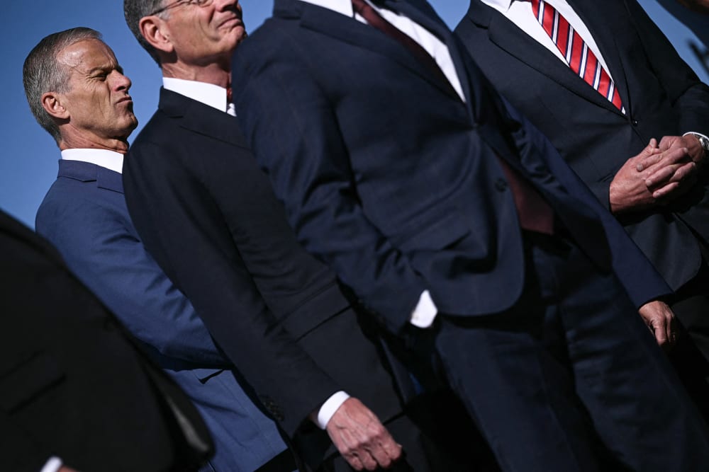 Senate Majority Leader John Thune, left, attends a news conference with Republican Congressional leadership, all dressed in suits, outside the Capitol.