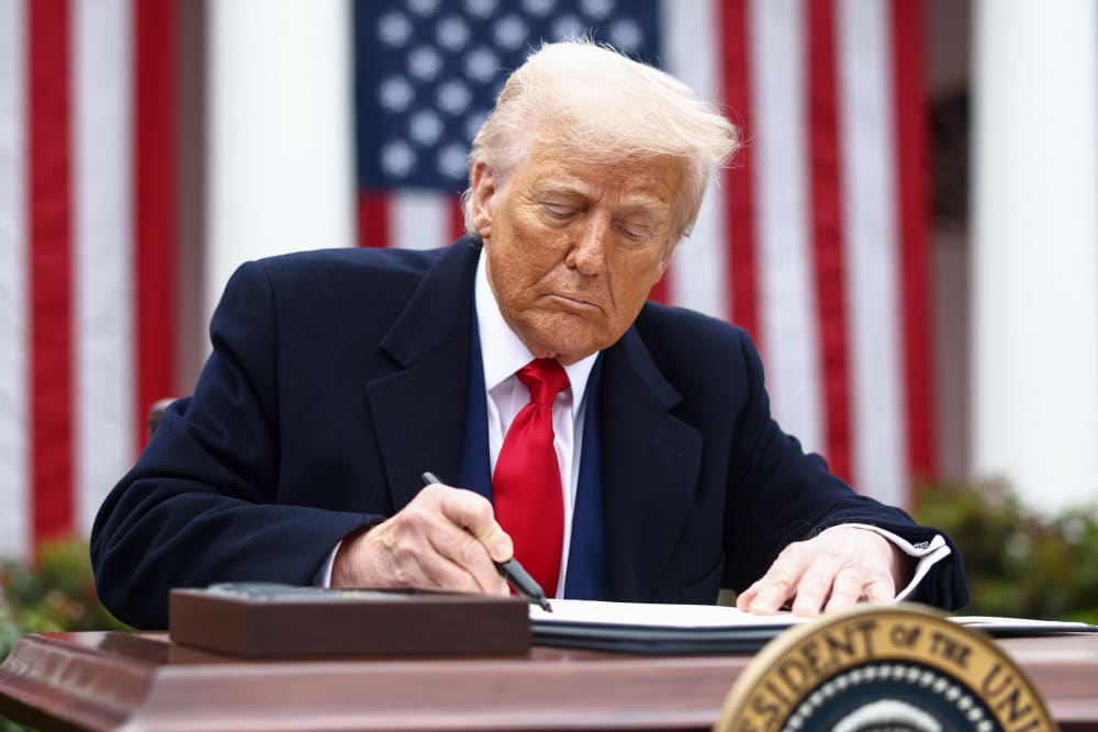 President Donald Trump signs an executive order on April 2, 2025, in the Rose Garden of the White House.