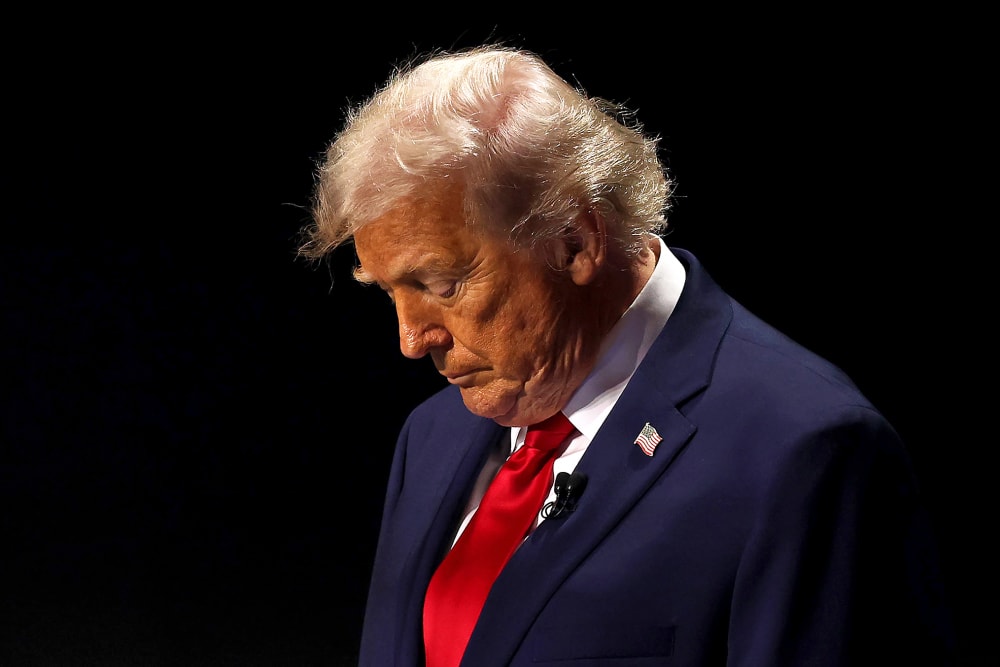 U.S. President Donald Trump with his head down.