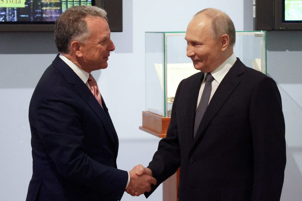 Russia's President Vladimir Putin shakes hands with US President Donald Trump's envoy Steve Witkoff.