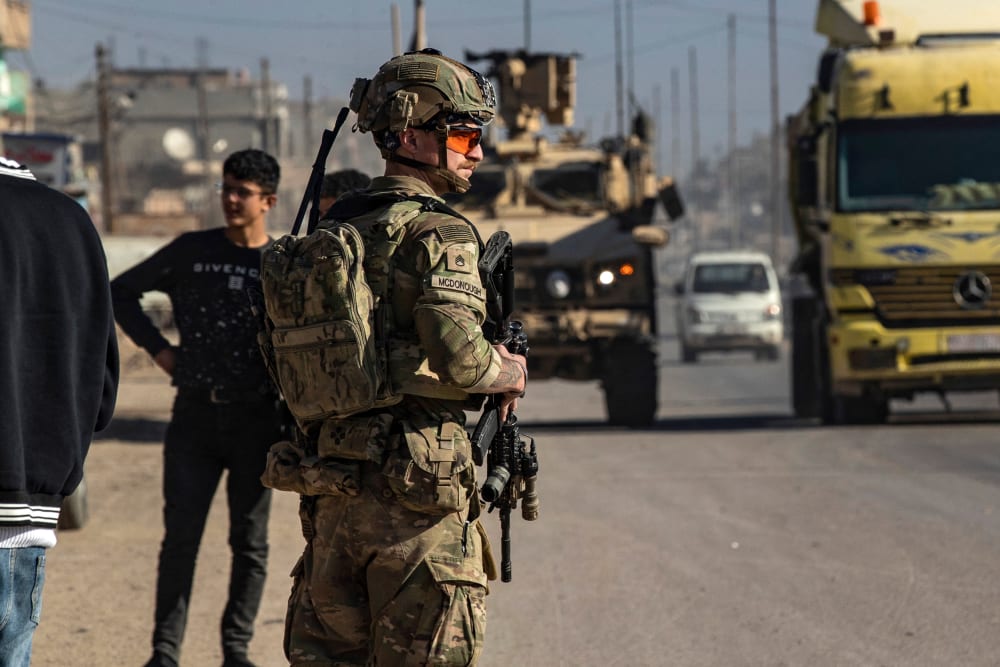 A US soldier keeps watch during a patrol in Syria.