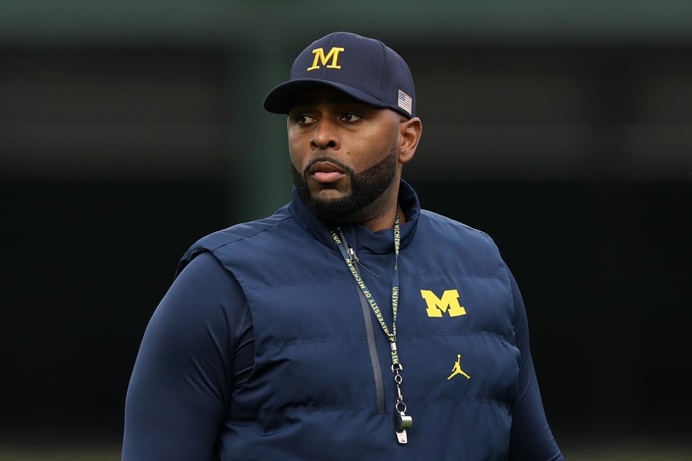 Former University of Michigan Sherrone Moore of the Michigan Wolverines observes practice prior to a game.