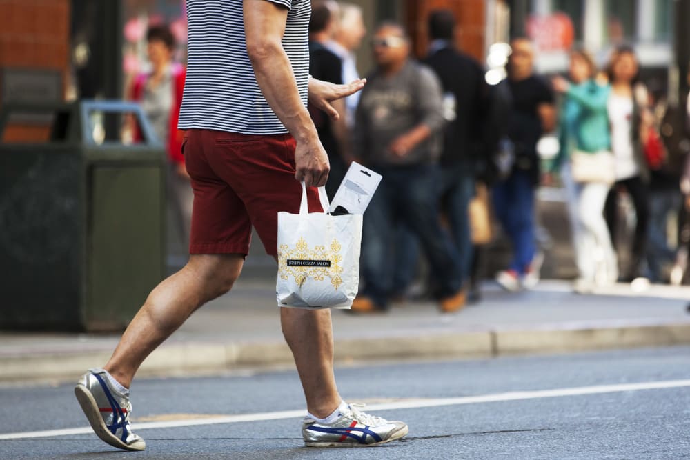 A man carries a plastic shopping bag on September 30, 2014 in San Francisco, California.