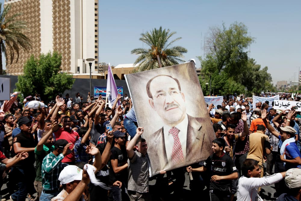 People carry portraits of Nuri al-Maliki as they gather in support of him in Baghdad on Aug. 13, 2014.