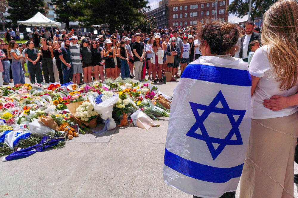 People gather at a memorial outside the Bondi Pavilion to mourn those killed in a mass shooting attack in Sydney.