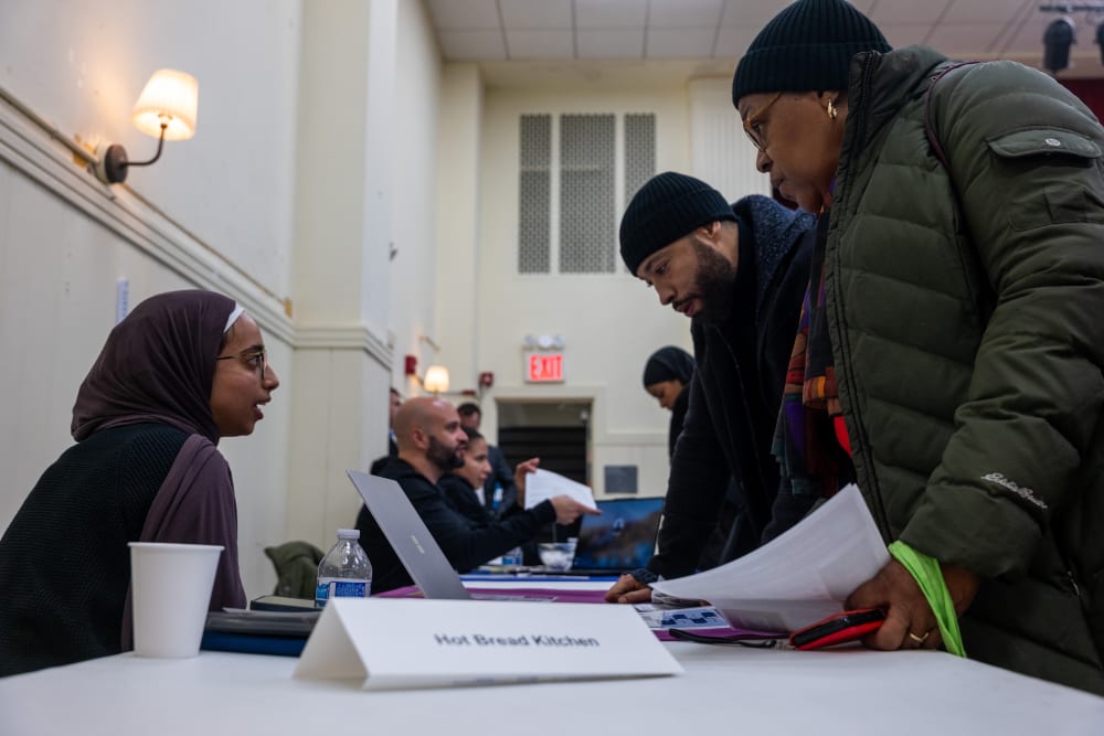 Job seekers attend a career fair in Harlem hosted.