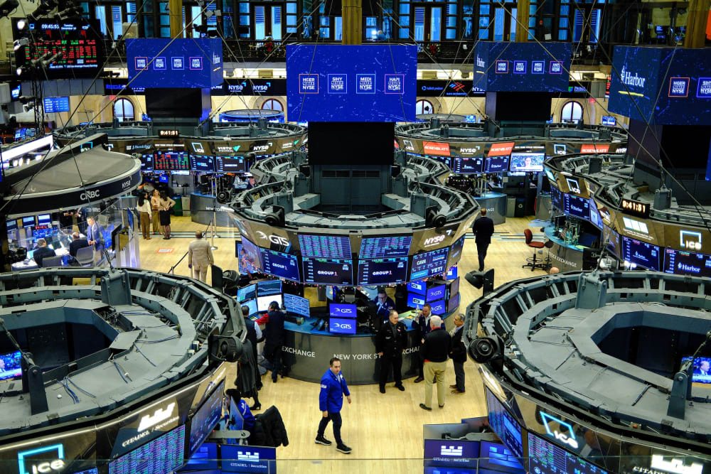 Traders work on the floor of the New York Stock Exchange at the opening bell in New York.