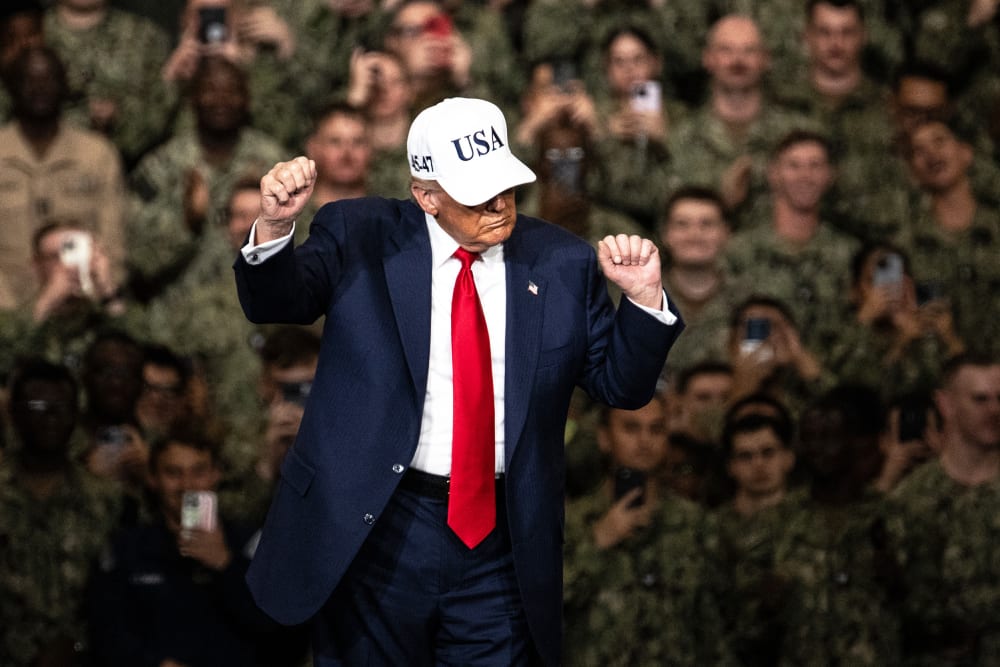 President Donald Trump dances in front of troops.