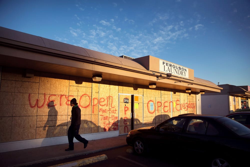 Plywood covers the glass front of a strip mall along West Florissant Street on Nov. 14, 2014 in Ferguson, Mo.