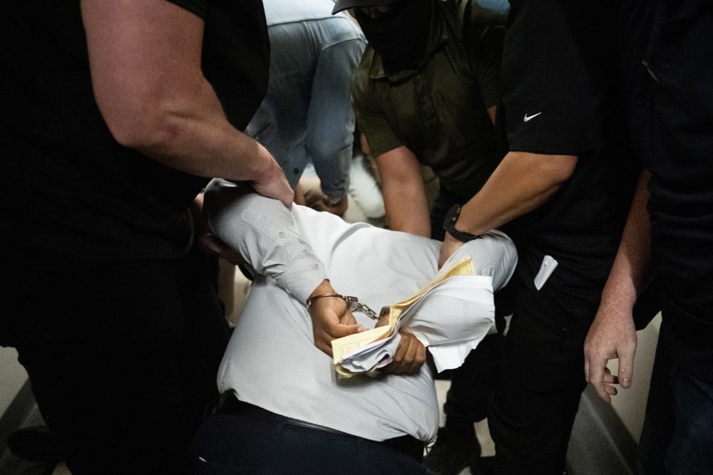 Ice agents detain a person as he exits an immigration courtroom hearing at the Jacob K. Javitz Federal Building.