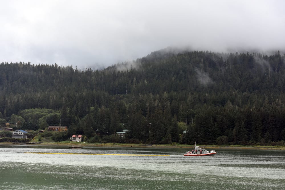 A Coast Guard Station Juneau boat tows a section of containment boom on Sept. 13, 2015, in Juneau, Alaska. (Photo by Grand DeVuyst/U.S. Coast Guard/AP)