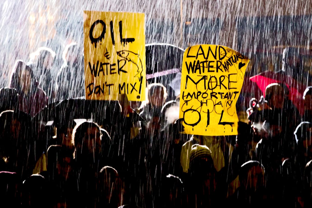 Wet snow falls as protesters demonstrate against the Enbridge Northern Gateway Pipeline in Vancouver, B.C., Jan. 14, 2013.