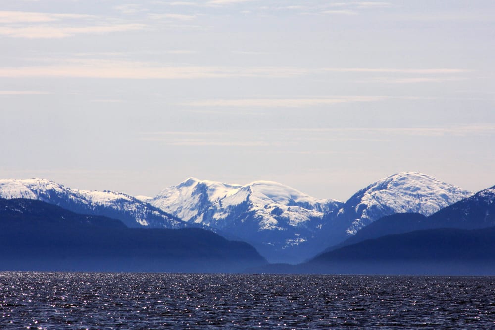 Snow-capped mountains peak out over a cove area favored by fishermen in the Douglas Channel, in northern British Columbia near to where Enbridge Inc plans to build its Northern Gateway pipeline terminal facility April 13, 2014.