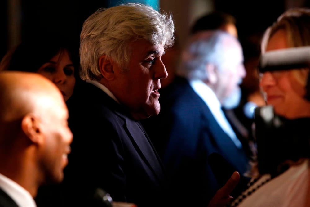 Honoree Jay Leno talks to reporters on the red carpet for the taping of the Mark Twain Prize for Humor ceremony and performance at the Kennedy Center in Washington on Oct. 19, 2014.