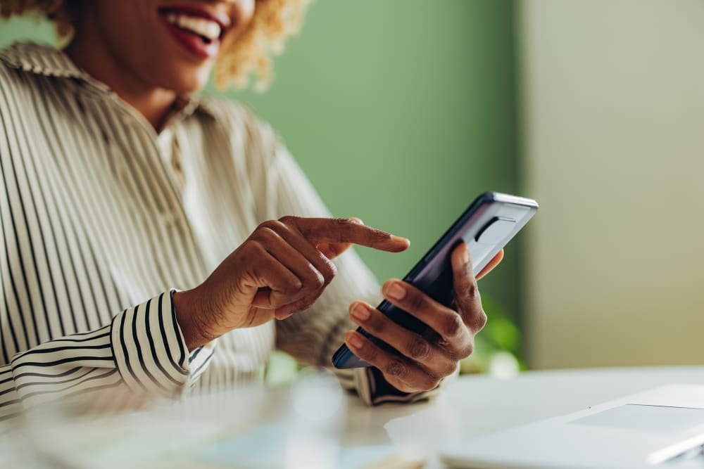 African American woman using social media on her phone.