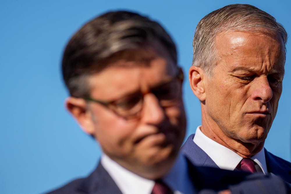 Speaker of the House Mike Johnson and Senate Majority Leader John Thune both looking down and disappointed at a news conference.