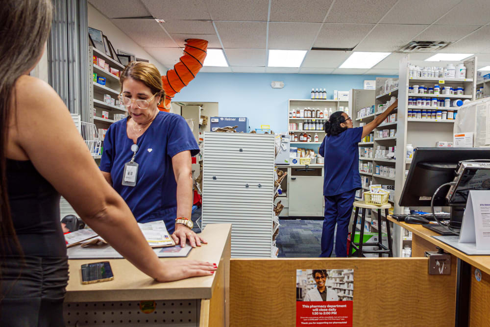 Two pharmacists at work at a CVS Pharmacy.