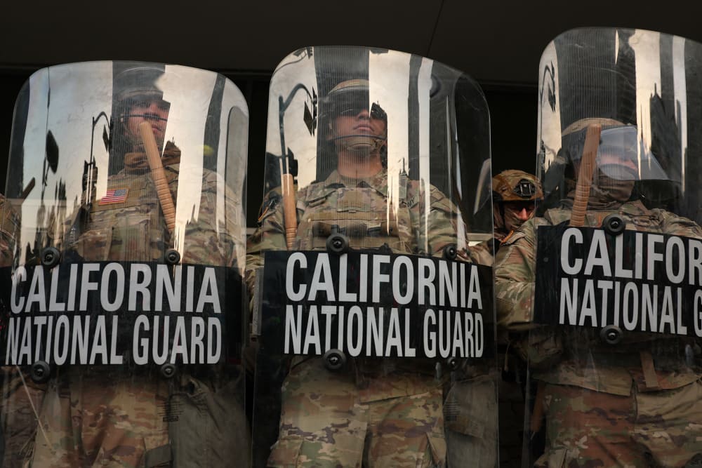 California National Guard stand behind shields on the steps of the Federal Building in Los Angeles.