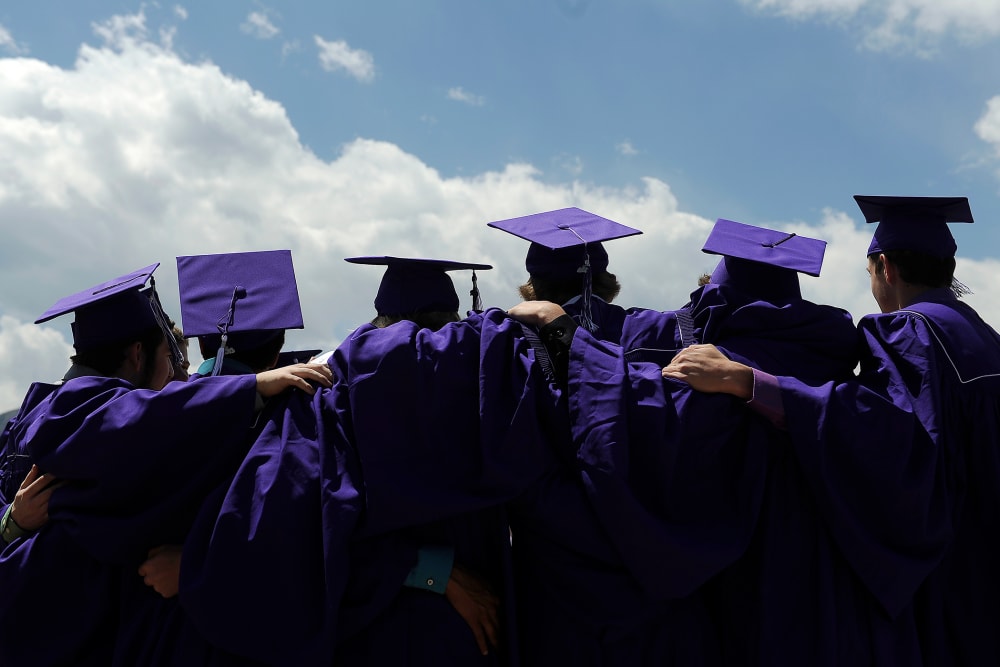 Students pose for photos before Arvada West High Schools graduation ceremony at the Coors Events Center on the Campus of the University of Colorado on May 22, 2013 in Boulder, Colorado.