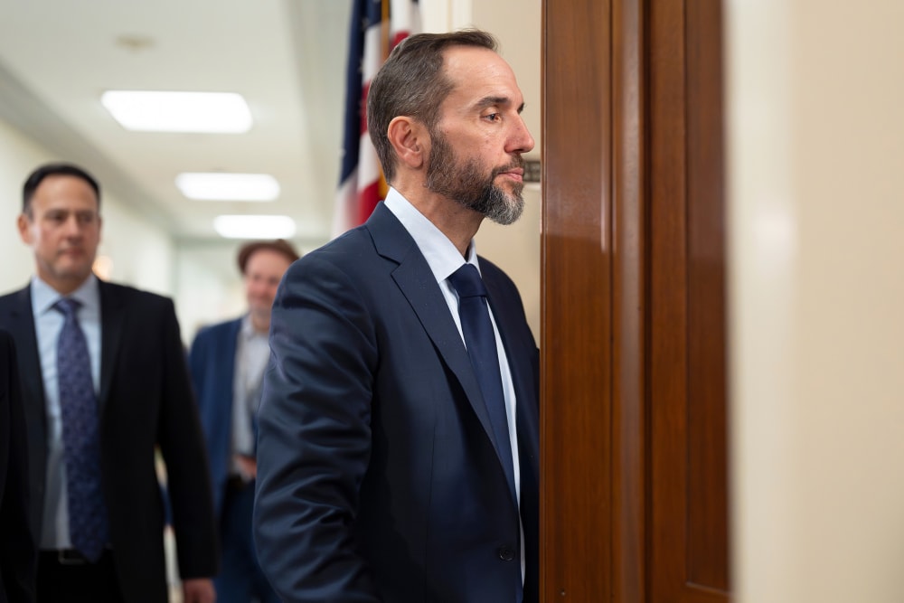 Former Department of Justice Special Counsel Jack Smith enters a room.
