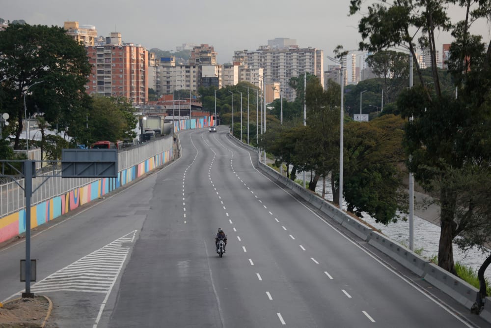 A motorcycle rides along an empty street in Caracas on January 3, 2026, after US forces captured Venezuelan leader Nicolas Maduro.