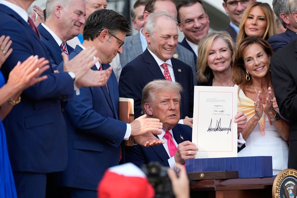 Congressional Republicans and Melania Trump surround President Donald Trump as he signs the "One, Big Beautiful Bill" Act.