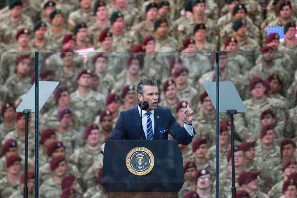 Pete Hegseth in front of a crowd of soldiers.