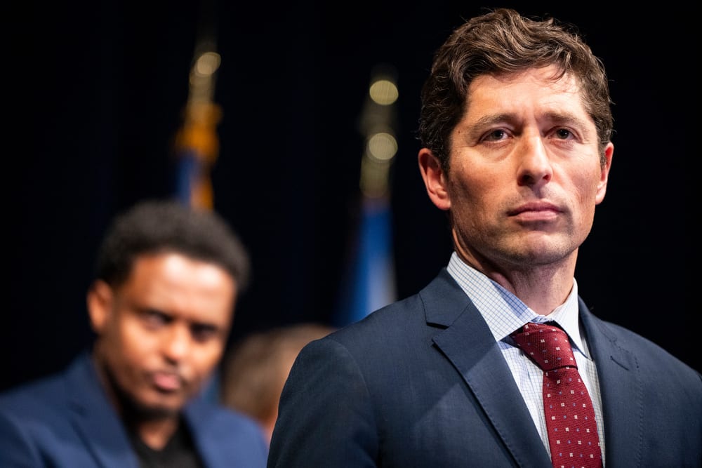 Minneapolis Mayor Jacob Frey looks into the distance.