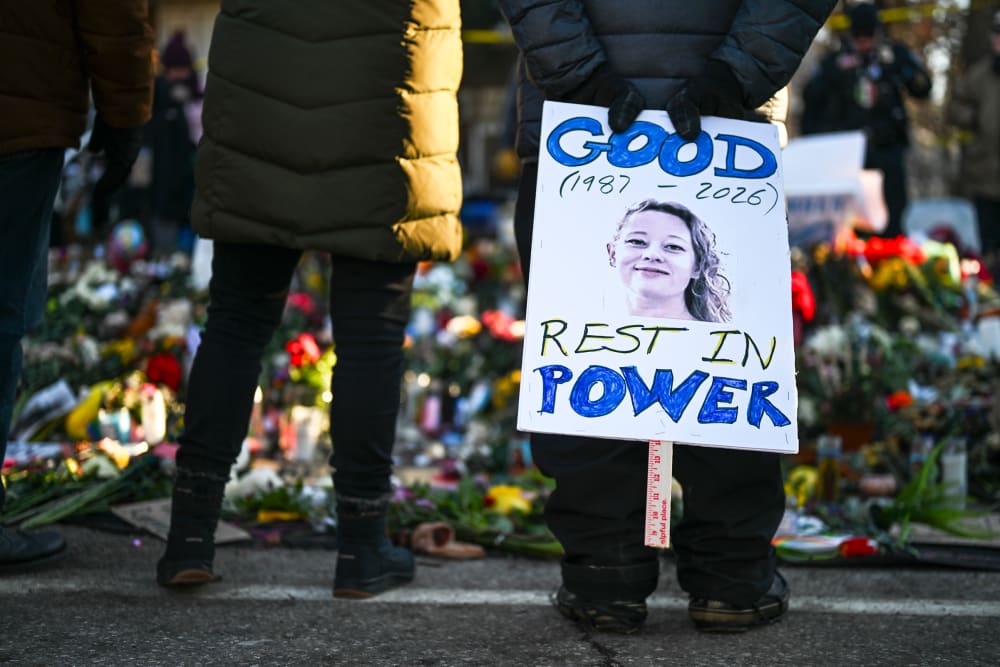 A person holds a sign reading "Good Rest in Power" during a vigil on Jan. 14, 2026, in Minneapolis.