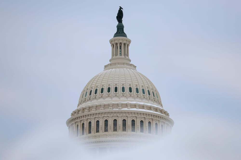 Snow frames the dome of the Capitol.