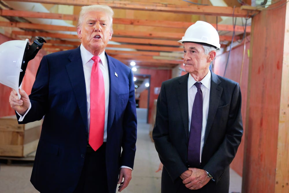 President Trump stands to the left of Fed Chair Jerome Powell as he speaks to the media.