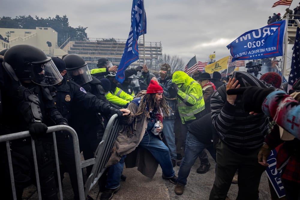 Trump supporters clash with the police - pushing each other.