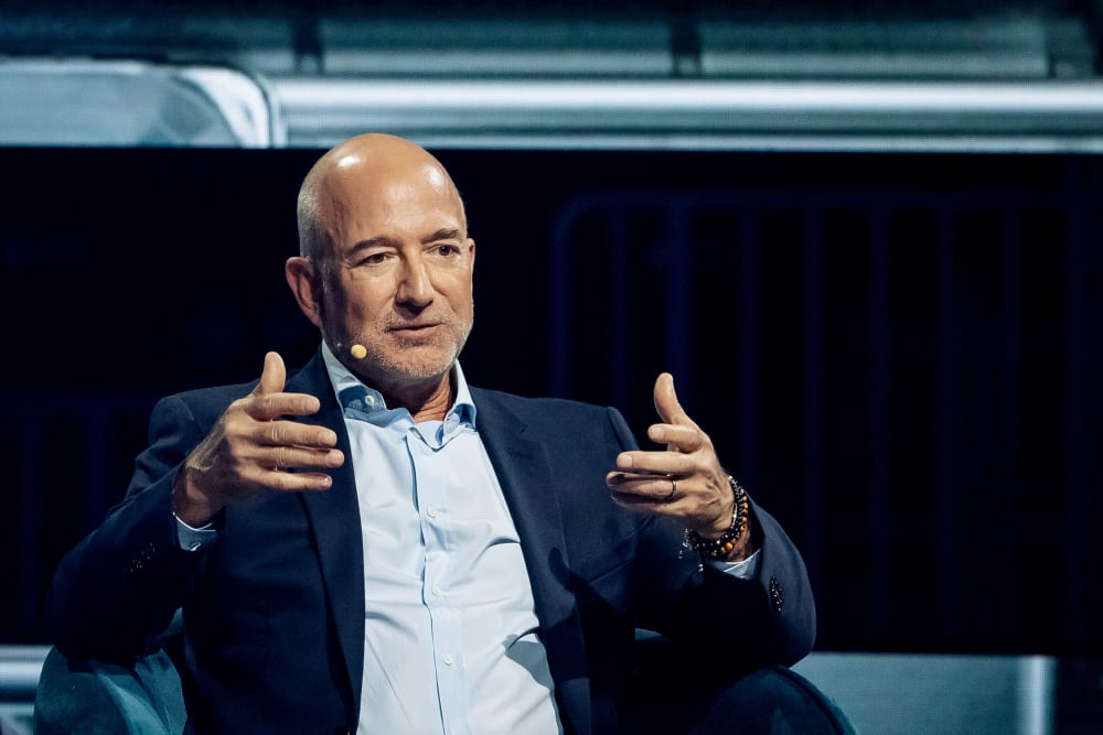 Jeff Bezos gestures with his hands.