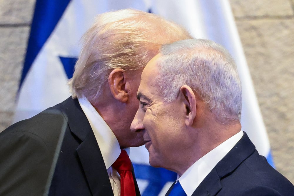 President Donald Trump's face is obscured behind Benjamin Netanyahu's.