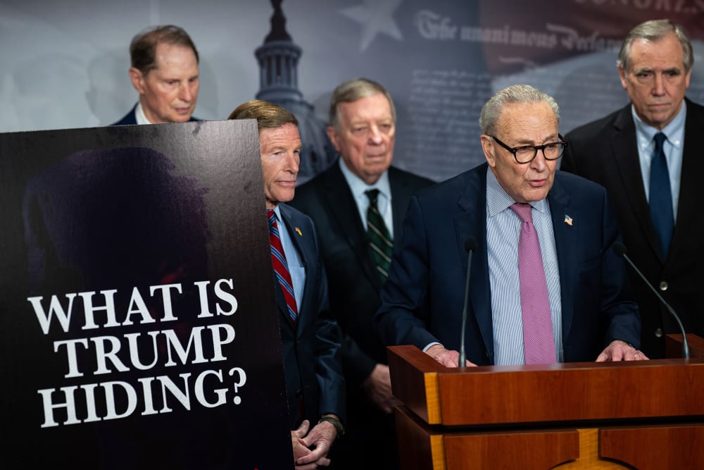 From left: Senator Ron Wyden, Senator Richard Blumenthal, Senator Dick Durbin, Senate Minority Leader Chuck Schumer, and Senator Jeff Merkley. On the left, a poster board that reads "WHAT IS TRUMP HIDING?"