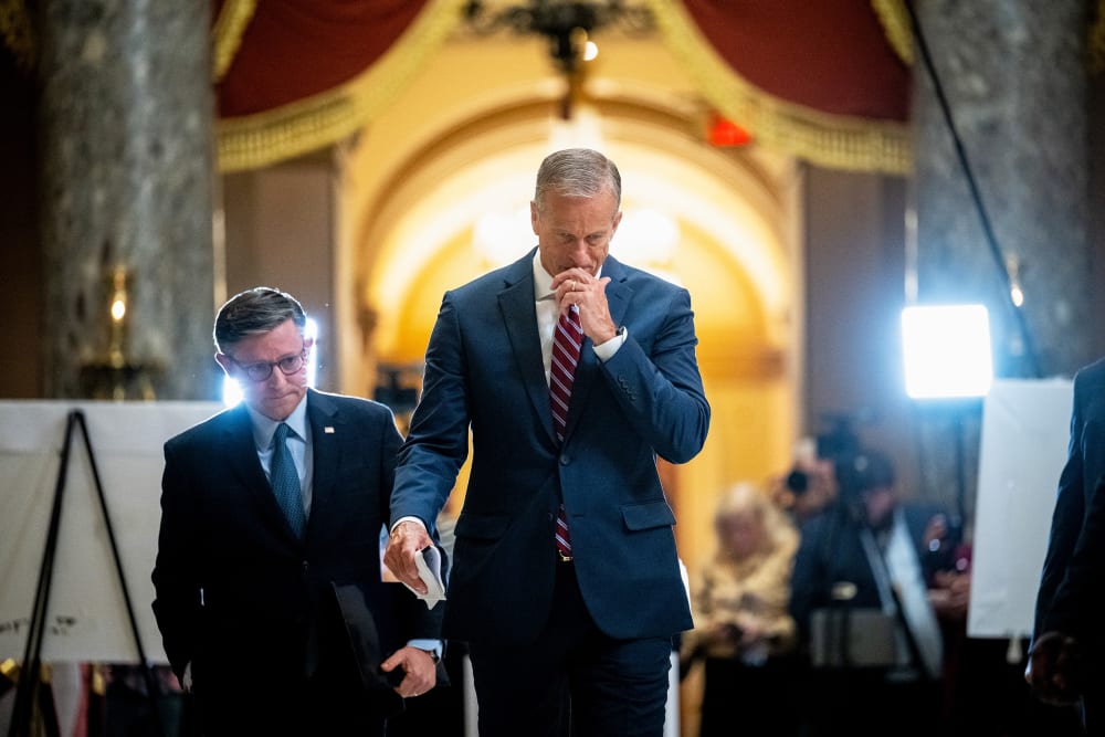 Mike Johnson, left, and John Thune leave. Press can be seen in the background.