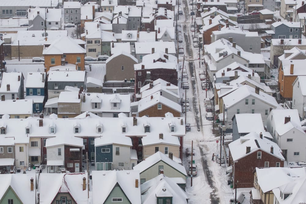 An aerial view of snow-covered homes.