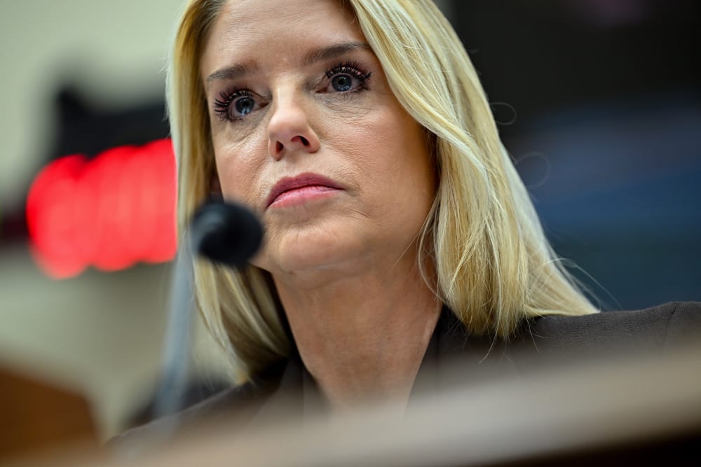A close up of Pam Bondi behind a microphone.