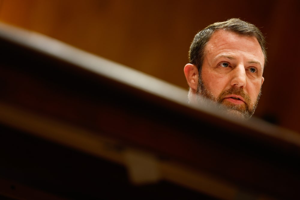 Markwayne Mullin's face visible behind a desk.