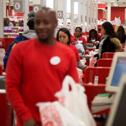 Employees ring customers up at cash registers inside a Target store in Jersey City, N.J.