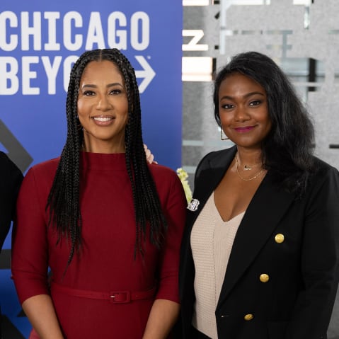 Mika Brzezinski, Liz Dozier, and Tatyana Ali in front of a Chicago Beyond sign.