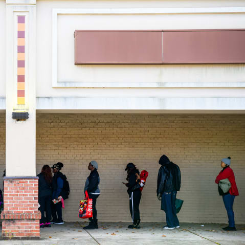 Furloughed federal workers wait in line at a Capital Area Food Bank distribution site.