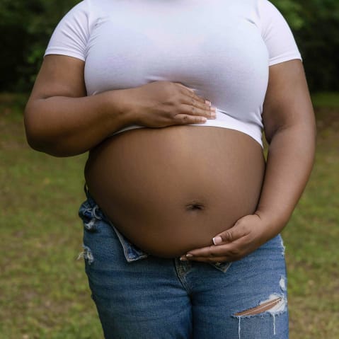 A pregnant Black woman.