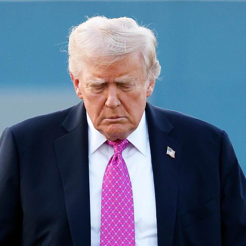 U.S. President Donald Trump looking down.