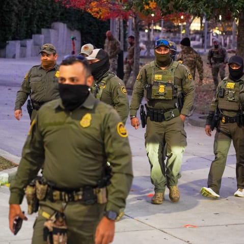 Federal Agents walk through a park in Downtown Charlotte, NC.