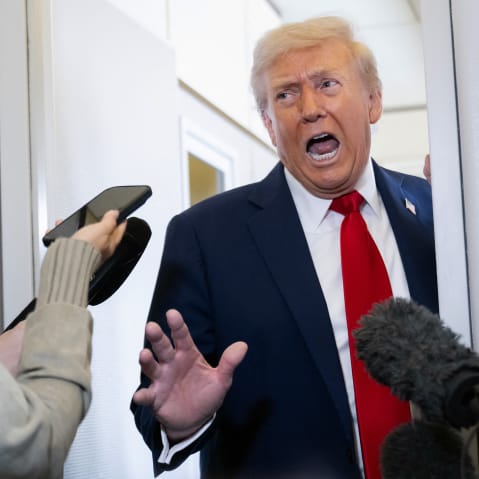President Donald Trump speaks with the media aboard Air Force One.
