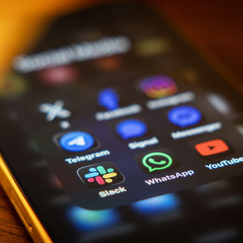 Social media and messaging apps on a mobile phone screen.